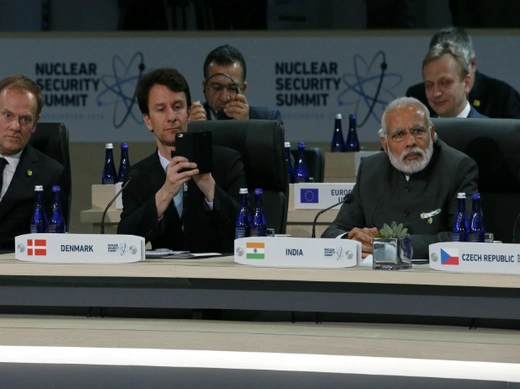 A member of Denmark's delegation (C) takes a picture with his phone while seated next to India's Prime Minister Narenda Modi (R) at the start of the second plenary session of the Nuclear Security Summit in Washington April 1, 2016 (Jonathan Ernst/Reuters).