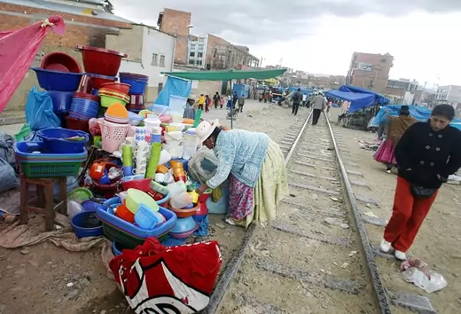 An Aymara woman displays her products next to a railway track in the market of El Alto on the outskirts of La Paz