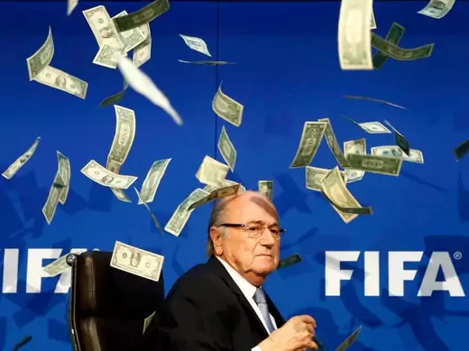 British comedian known as Lee Nelson (unseen) throws banknotes at FIFA President Sepp Blatter as he arrives for a news conference after the Extraordinary FIFA Executive Committee Meeting at the FIFA headquarters in Zurich, Switzerland July 20, 2015. World football's troubled governing body FIFA will vote for a new president, to replace Sepp Blatter, at a special congress to be held on February 26 in Zurich, the organisation said on Monday (Reuters/Arnd Wiegmann).