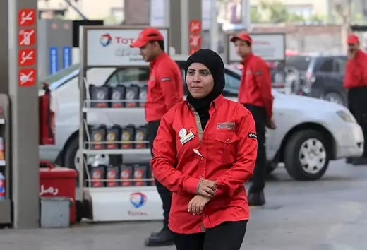 A female employee is seen as she works at a petrol station in Cairo