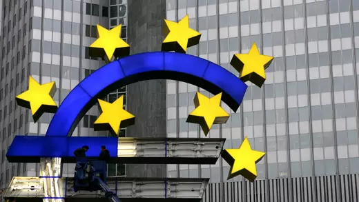 Workers repair the euro sign in front of ECB headquarters