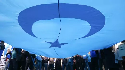 Protesters hold an East Turkestan flag during a demonstration in Berlin to protest against deadly riots in China’s northwestern region of Xinjiang, July 10, 2009. 