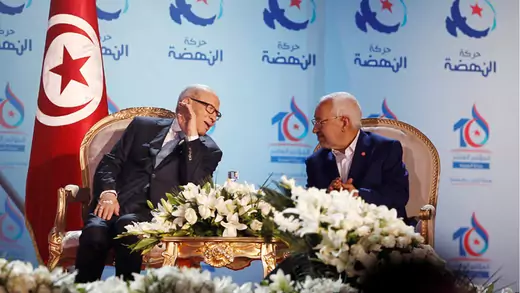 Tunisian President Beji Caid Essebsi talks with Rachid Ghannouchi, leader of the Ennahda movement, during a party congress in Tunis.