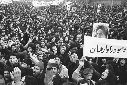 A poster of exiled Muslim leader Ayatollah Khomeini is carried by marchers with clenched fists during the anti-Shah demonstrations in Tehran, December 11, 1978. Michel Lipchitz/AP