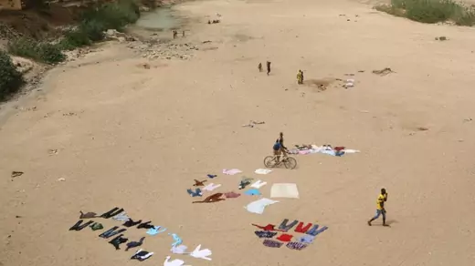 People wash clothes in a dry riverbed in Maroua, Cameroon