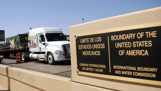 Mexican commercial trucks cross into the United States.