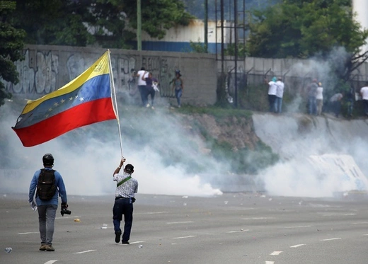 Opposition supporters clash with security forces during a rally against Venezuela's President Nicolas Maduro in Caracas