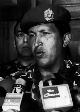 Chávez talks to reporters after surrendering to troops loyal to Pérez.  AP Images/Ali Gomez