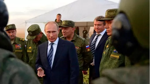 Russian President Vladimir Putin talks to servicemen during a training exercise at the Donguz testing range in Orenburg region, Russia, September 19, 2015