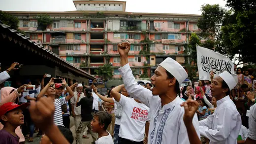 Supporters of Jakarta gubernatorial candidate Anies Baswedan celebrate as ballots are counted outside a polling station, April 19, 2017.