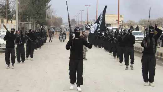 Islamic State militants parade in Tel Abyad, near Syria's border with Turkey.