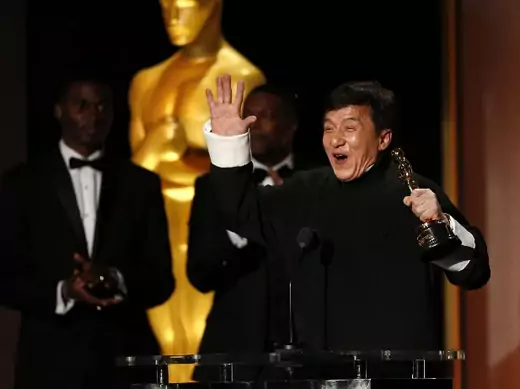 Actor Jackie Chan reacts as he accepts his honorary award as actor Chris Tucker (C) looks on at the 8th Annual Governors Awards in Los Angeles, California on U.S., November 12, 2016. (Mario Anzuoni/Reuters)