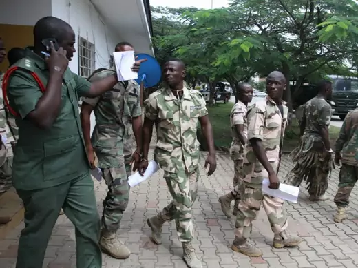 Nigerian soldiers exit a court-martial hearing.