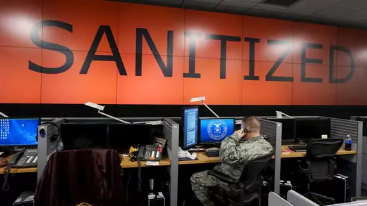 A U.S. Air Force airman works under a data wall with screens blanked during a reporter's visit at Petersen Air Force Base in Colorado Springs, Colorado.