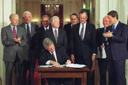 U.S. President Bill Clinton signs a side deal of NAFTA. Ron Edmond/AP