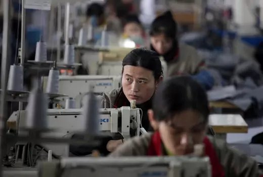 An employee works at a clothes factory in Huaxi village, of Jiangsu Province, on December 3, 2010. (Carlos Barria/Reuters)