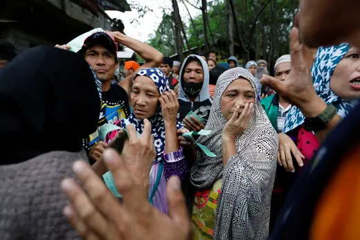 Displaced residents lineup for food in Marawi City as government forces fight militants. 