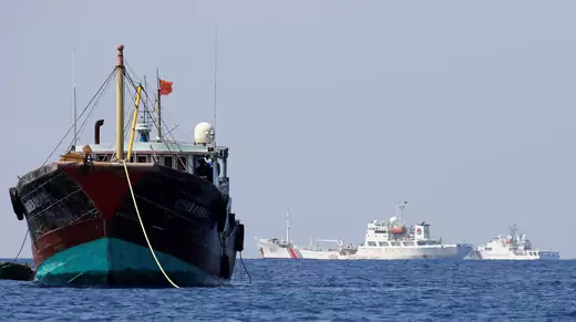China Coast Guard vessels patrol past a Chinese fishing vessel at the disputed Scarborough Shoal, April 5, 2017.