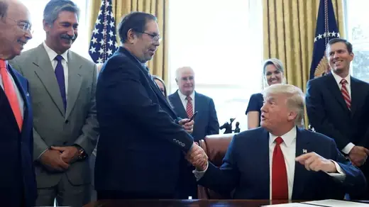 Trump hands pen to president of the United Steelworkers