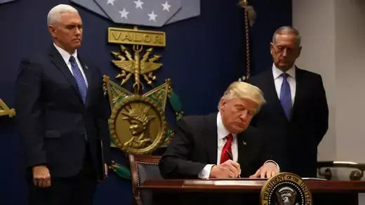 President Donald J. Trump signs an executive order on new immigration restrictions.