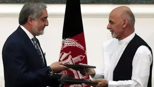 Abdullah Abdullah and Ashraf Ghani exchange signed agreements to form a unity government.