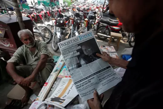 A man reads a newspaper with news about the disqualification of Pakistan's Prime Minister Nawaz Sharif by the Supreme Court, at a news stand in Peshawar, Pakistan July 29, 2017.