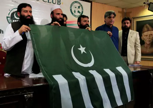 Saifullah Khalid (2nd L), president of the Milli Muslim League political party, holds a party flag with others during a news conference in Islamabad, Pakistan, August 7, 2017. Faisal Mahmood/Reuters