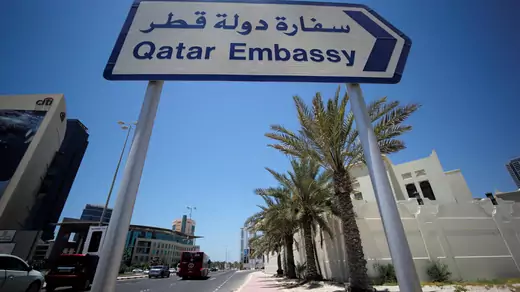 A sign indicating a route to Qatar embassy in Bahrain