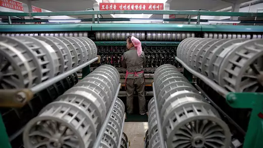A woman works at a textile mill in Pyongyang, North Korea. 