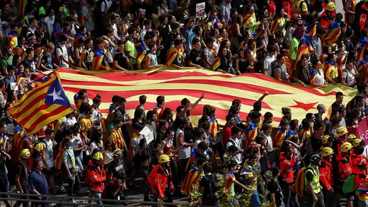 Students demonstrate with Catalan separatist flags in Barcelona.