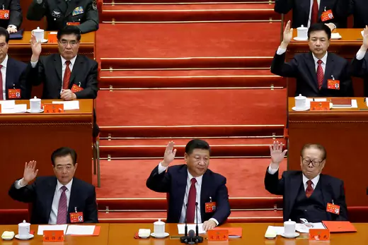 Former Chinese president Hu Jintao, Chinese President Xi Jinping and former Chinese president Jiang Zemin raise their hands as they take a vote at the closing session of the 19th National Congress of the Communist Party of China, in Beijing, China.