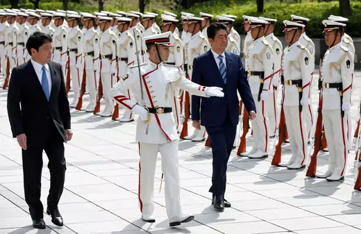 Japan's Prime Minister Shinzo Abe (R) and Defense Minister Itsunori Onodera (L) review the honour guard before a meeting with Japan Self-Defense Force's senior members at the Defense Ministry in Tokyo, Japan, September 11, 2017.