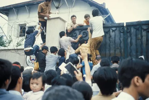South Vietnamese scale the walls of the U.S. embassy in Saigon to flee advancing North Vietnamese forces, April 1975. 
