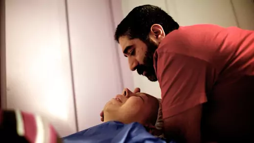 A man comforts his fiancée, a patient at a breast cancer clinic in Tehran, Iran. With little access to preventive and primary care, working-age people in poorer nations are more likely to develop and receive late diagnoses for breast cancer and other NCDs.