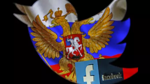 A Russian flag and a 3-D model of the Facebook logo is seen through a cutout of the Twitter logo in this photo illustration taken in Zenica, Bosnia and Herzegovina, on May 22, 2015.