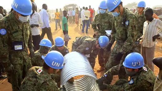 United Nations Mission in South Sudan peacekeepers from Japan assemble a drainage pipe at Tomping camp, where some 15,000 people who fled their homes following recent fighting are sheltered by the United Nations, in Juba January 7, 2014.