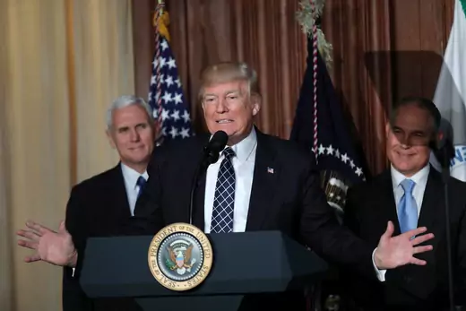 U.S. President Donald Trump speaks between Vice President Mike Pence (L) and EPA Administrator Scott Pruitt prior to signing an executive order on "Energy Independence," eliminating Obama-era climate change regulations, March 28, 2017.