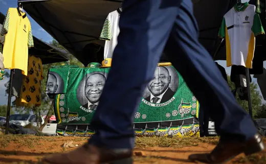 A man walks past ANC merchandise with the face of newly elected president Cyril Ramaphosa outside the venue of the 54th National Conference of the ruling African National Congress (ANC) at the Nasrec Expo Centre in Johannesburg, South Africa December 19, 2017.