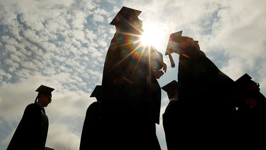 Graduating students arrive for commencement exercises at Boston College in Boston, Massachusetts, on May 20, 2013.