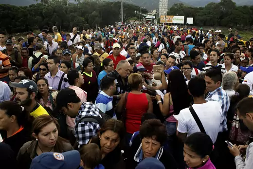 People cross over the Simon Bolivar international bridge to Colombia from San Antonio del Tachira.