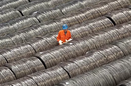 A worker checks steel wires at a warehouse in Dalian, Liaoning province, China.