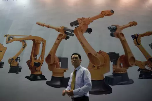 A man walks past a billboard at 2017 China International Robot Show in Shanghai