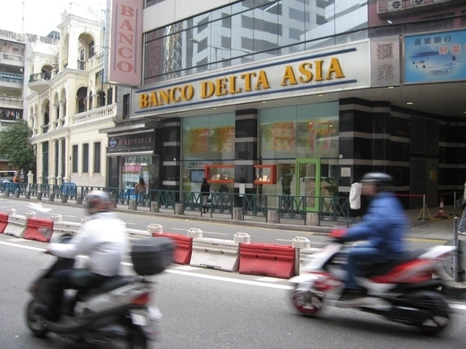 A commuters pass by a Banco Delta Asia bank branch in Macau.