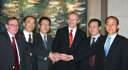 Negotiators in Beijing shake hands after the fourth round of the Six Party Talks.