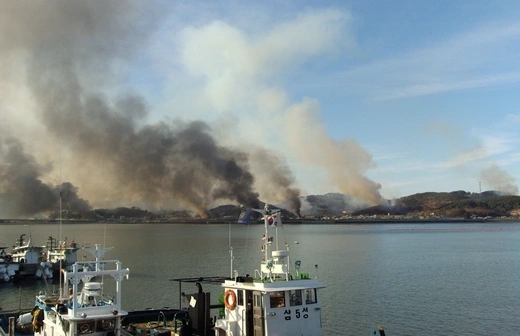 Smoke rises from Yeonpyeong after North Korean artillery hit the South Korean island.