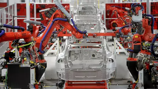 Robotic arms assemble Tesla Model S sedans at the company's factory in Fremont, California.