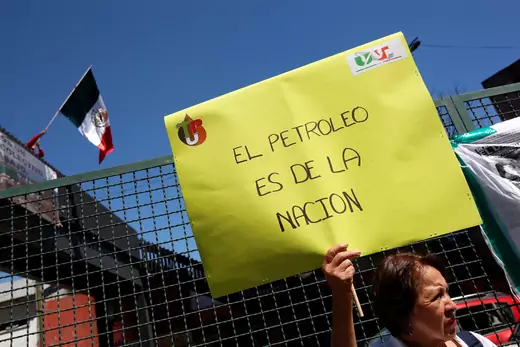 A union worker holds a placard as she protests outside Pemex headquarters to demand better contracts for technicians and other professionals, in Mexico City, Mexico November 7, 2017. The placard reads: "The oil is from the nation"