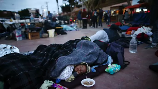 Members of a caravan of migrants from Central America sleep near the San Ysidro checkpoint