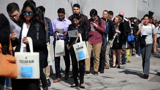 People wait in line to attend a technology job fair in Los Angeles. 