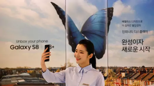 A model poses with a Samsung smartphone. 
